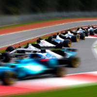 F1 racing cars speeding on the track